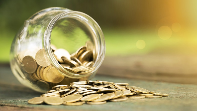 Coins in jar (Reddogs/Shutterstock.com)