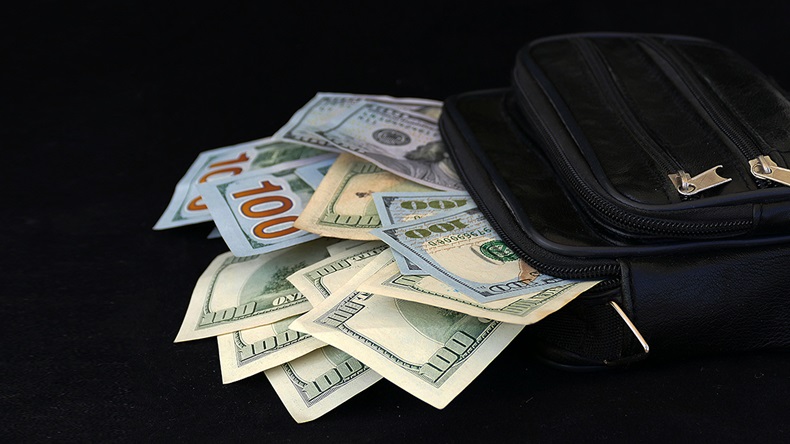 US dollars overflowing (hanif66/Shutterstock.com)